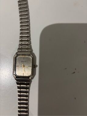 Phasar silver-toned square face wristwatch with gold-toned hands